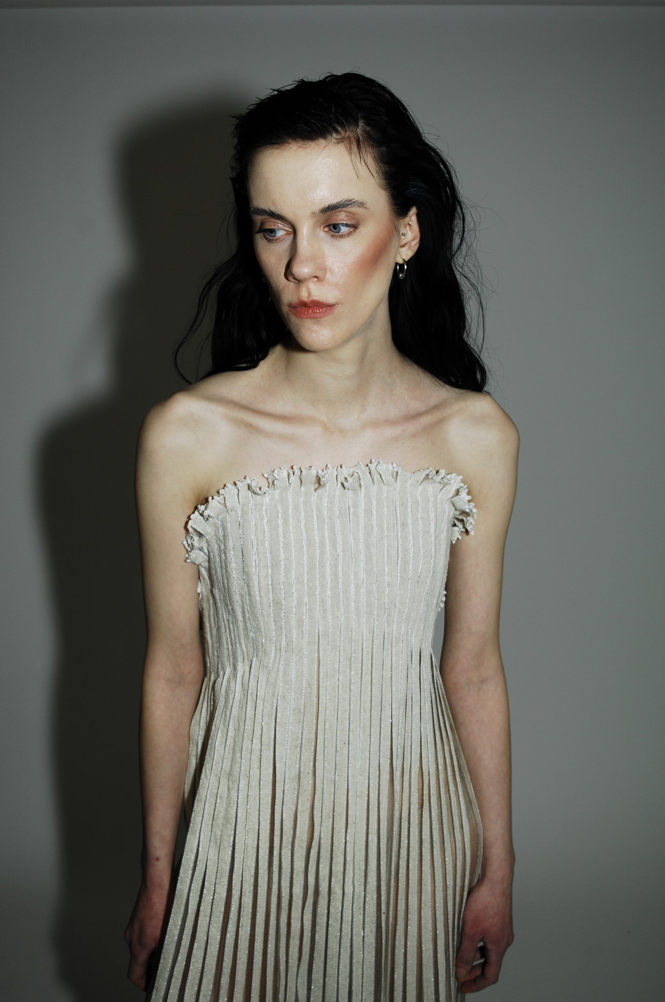 "Love Remains" dress - Rouba G's stunning handwoven maxi dress, symbolizing love's resilience and beauty, with intricate mosaic-like design and a sophisticated corseted upper.
