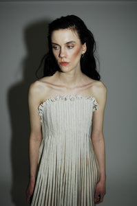 "Love Remains" dress - Rouba G's stunning handwoven maxi dress, symbolizing love's resilience and beauty, with intricate mosaic-like design and a sophisticated corseted upper.
