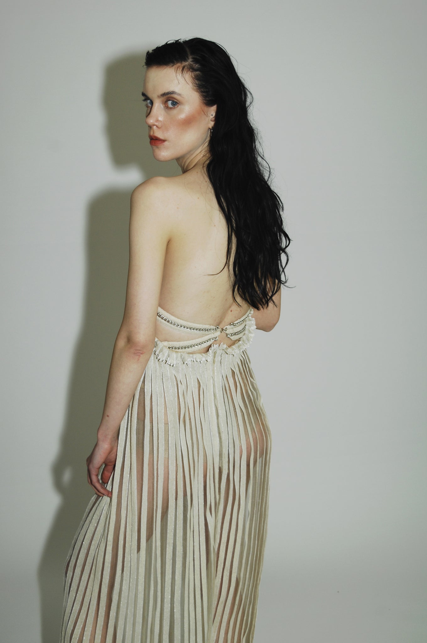 "Love Remains" dress - Rouba G's stunning handwoven maxi dress, symbolizing love's resilience and beauty, with intricate mosaic-like design and a sophisticated corseted upper.