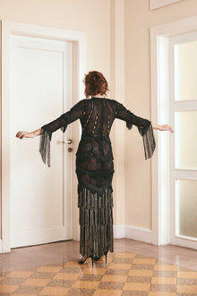 Elegant black lace dress with intricate fringes, offering a blend of sophistication and trendiness. Designed for ladies who appreciate unique fashion and desire a standout look for formal events