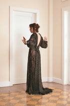Black two-tone dress made of plain woven silk and lace, with long puffy sleeves and a backless style, ideal for fashion-forward women