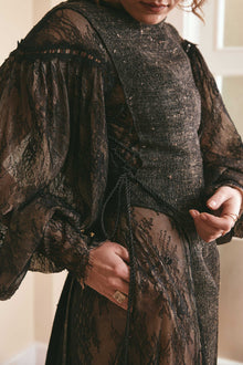 Black two-tone dress made of plain woven silk and lace, with long puffy sleeves and a backless style, ideal for fashion-forward women