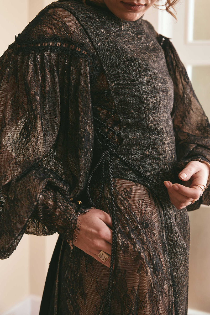 Black two-tone dress made of plain woven silk and lace, with long puffy sleeves and a backless style, ideal for fashion-forward women